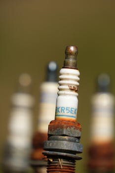pexels photo 36086528 36086528 Detailed view of rusted spark plugs, showcasing industrial decay.
